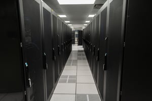 An image showing a row of in a data center illustrating how a raised look is used in data center cooling.