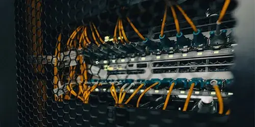 An image of servers in a data center linked using a fiber optic cross connect.